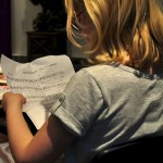 My daughter, reading the Four Questions at an Or Emet seder.